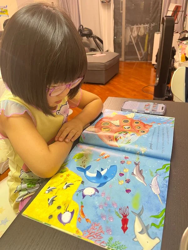 Child using Lestori at home (face blurred for privacy).